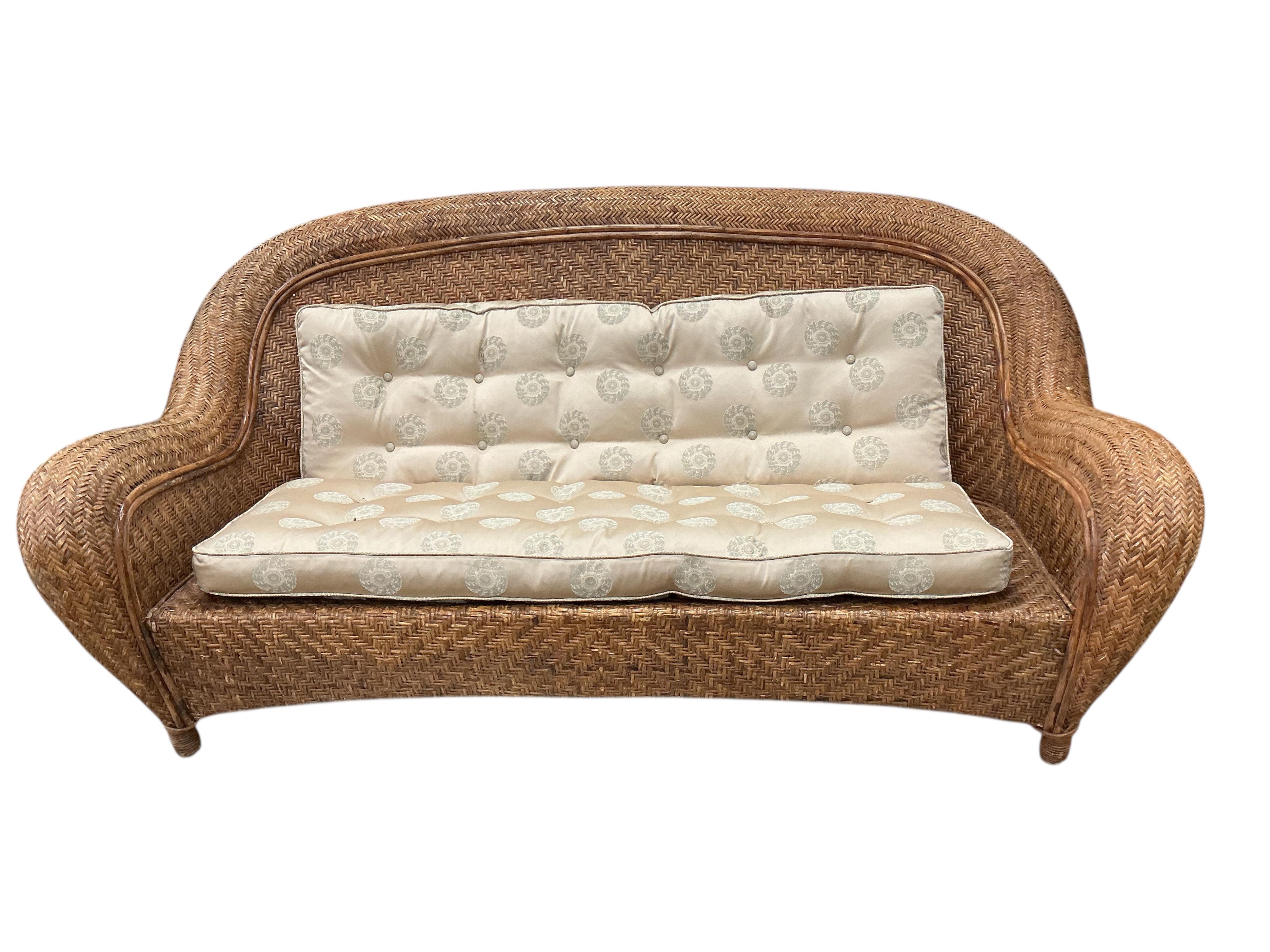 A rattan conservatory settee with associated cushion seat and back, width 186cm, depth 94cm, height 86cm